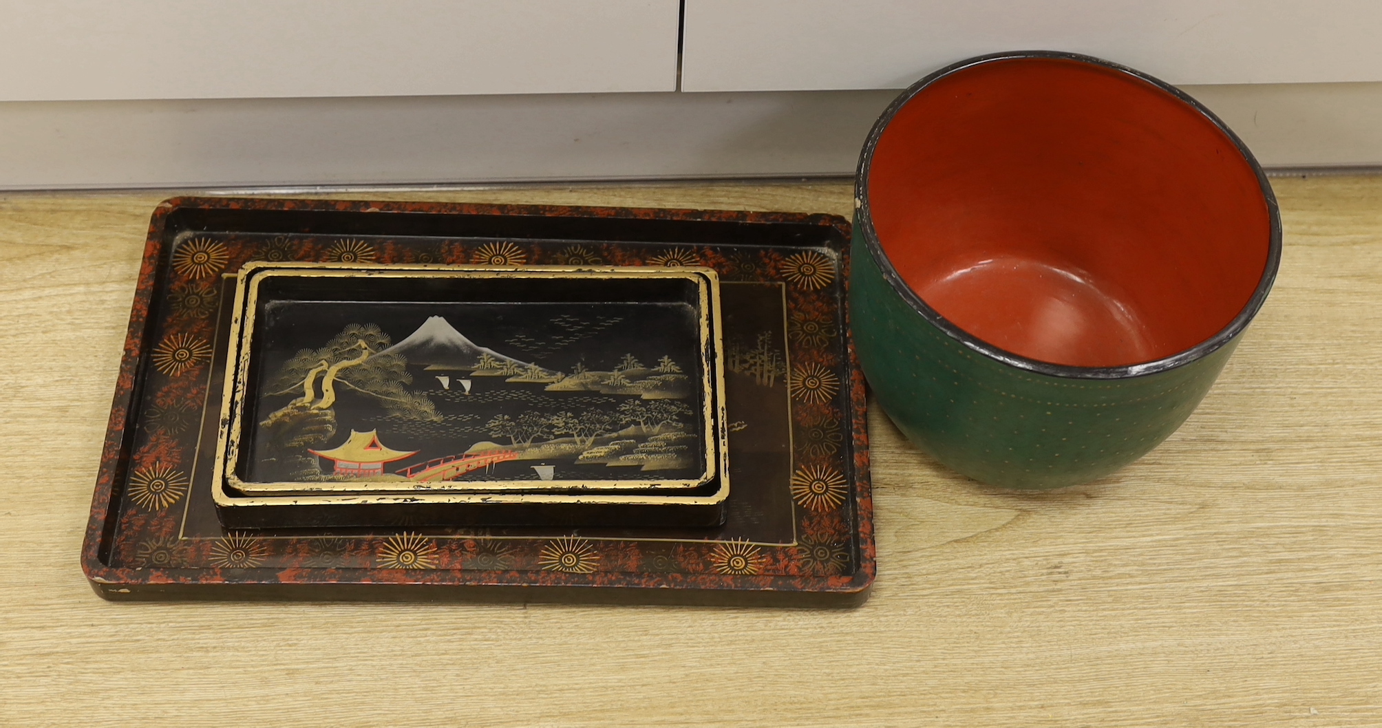 A Thai lacquer bowl and three Chinese lacquer rectangular trays, bowl 18.5cm high